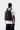 Sac à dos Carhartt WIP Kickflip noir porté par un homme de dos, avec multiples sangles, boucles et le logo Carhartt.