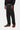 Pantalon Newel Carhartt WIP noir délavé pour homme, associé à un sweat noir et des chaussures bateau marron.