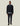 Homme portant la Veste Como Hybrid Les Deux bleu marine, chemise bleue claire, pantalon marine et mocassins noirs sur fond clair.