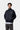 Veste Bolon Carhartt WIP bleu marine foncé portée par un mannequin, avec logo blanc, fermeture éclair et poches.