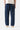 Rear view of model wearing Service Works Classic Chef Pants in dark blue, with orange brand tag on back pocket.