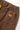 Close-up of Service Works Classic Chef Pants in brown, showing the back pocket with an orange label and elastic waistband.