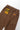 Back of brown Service Works Classic Chef Pants, showing elastic waistband and branded labels on both back pockets.