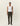 Homme portant le pantalon de costume fuselé Como Olive Night de Les Deux, un débardeur blanc et des mocassins bordeaux.