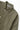 Service Works Easy Chef Shirt in olive green, close up showing the rounded collar, white buttons, and front pocket.