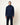 Homme portant un Hoodie Terry Homecore bleu marine et un pantalon assorti sur un fond clair.