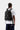 Sac à dos Carhartt WIP Kickflip noir porté par un homme de dos, avec multiples sangles, boucles et le logo Carhartt.