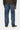 Pantalon Klondike Bleu Délavé Foncé Carhartt WIP porté, vue de dos, avec patch logo et baskets noires.
