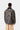 Carhartt WIP Lander Coat imprimé camouflage, vue de dos, avec col en velours côtelé noir et pantalon beige.