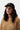 Casquette Carhartt WIP Madison Logo noire portée par une femme aux cheveux bouclés
