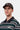 Casquette Carhartt WIP Madison Logo marron foncé sur un homme, portant un polo à rayures vert et blanc.