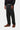 Pantalon Newel Carhartt WIP noir délavé pour homme, associé à un sweat noir et des chaussures bateau marron.
