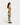 Pantalon Hemming M90 HOMECORE porté par une femme en profil, avec un motif géométrique vert, blanc et marron.
