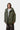 Parka Stanwood Cypress Carhartt WIP verte portée par un homme avec un col montant et une capuche, sur fond blanc.