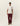 Homme portant un T-shirt Record Ivoire Les Deux, un pantalon marron et une casquette verte.