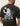 T-shirt Rural Les Deux vert foncé avec un imprimé graphique coloré au dos représentant une personne assise, des fleurs, un ballon et une bouteille.