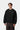 Homme portant le sweat Carhartt WIP Ebbert noir/blanc avec logo Carhartt blanc sur la poitrine.