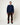 Homme portant un Sweat Terry Homecore bleu marine, pantalon en velours côtelé marron, et bottes de randonnée.