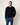 Homme portant le Sweat Terry Homecore noir, avec un col rond et un t-shirt blanc en dessous, et un jean bleu.