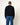 Homme de dos portant un pull Homecore Sweat Terry noir avec couture rouge verticale et jean bleu.