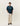 Mannequin portant le T-shirt Mesh Check Les Deux bleu canard et noir, un pantalon beige ample et des mocassins bruns.
