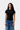 T-shirt Small Heart noir Carhartt WIP pour femme, orné d'un petit logo cœur et porté avec un jean bleu.