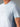 Gros plan d'un homme portant le T-shirt Technique MOLVENO AYAQ bleu clair avec panneau latéral côtelé.