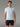 T-shirt Technique MOLVENO AYAQ bleu clair porté par un homme avec un short noir, idéal pour le sport.