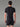 Dos d'un homme portant le T-shirt Trail/Running Stamina MOLVENO AYAQ noir et blanc, dos avec bande perforée, et short.