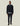 Homme portant la Veste Como Hybrid Les Deux bleu marine, chemise bleue claire, pantalon marine et mocassins noirs sur fond clair.